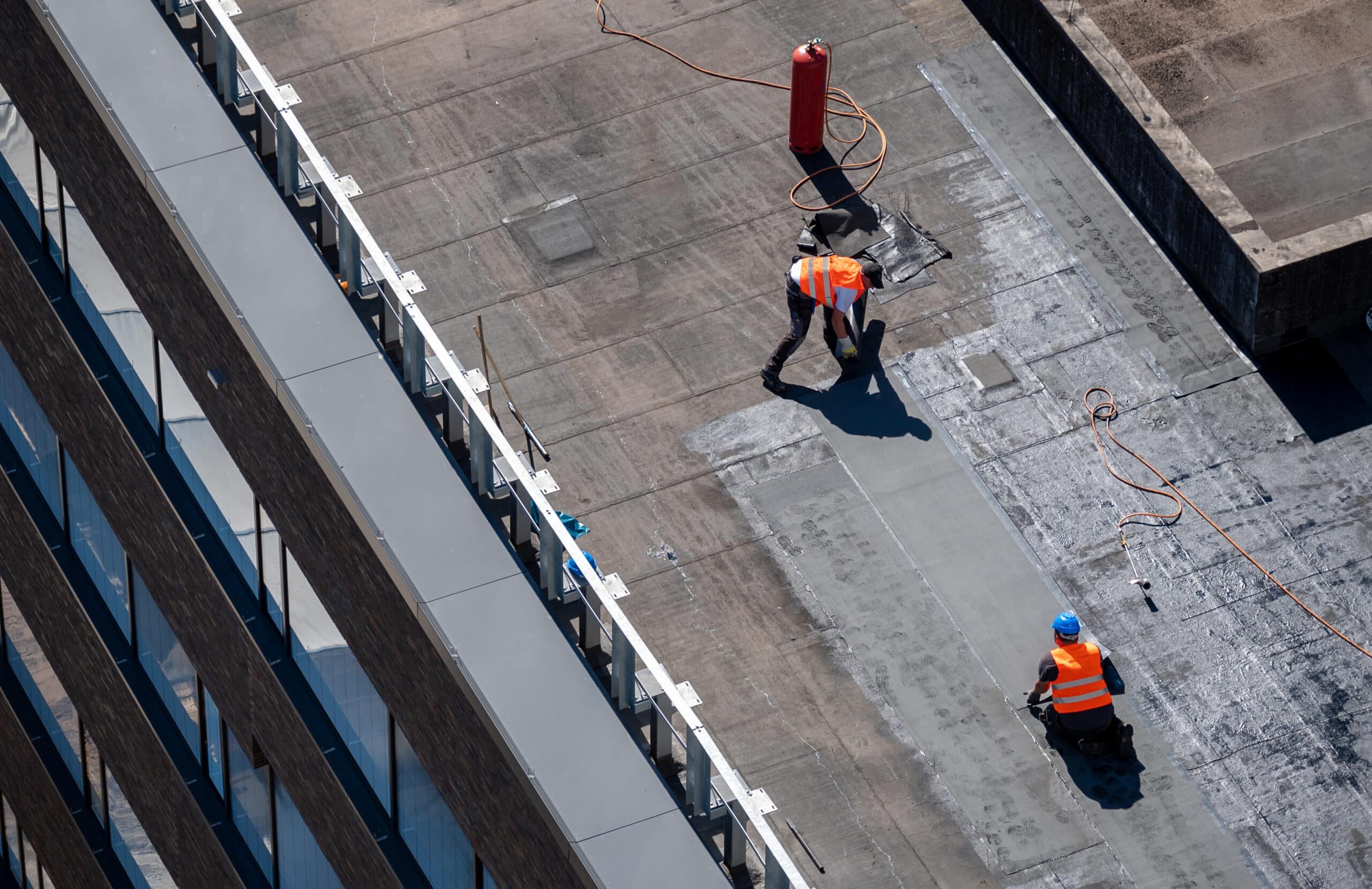 Workers installing a flat roof